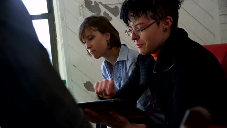 Group of art students using a digital tablet