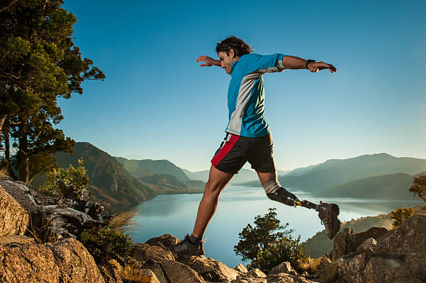 Runing in Patagonia Argentina Disabled man with prosthetic leg, runing in Patagonia. adaptive athlete stock pictures, royalty-free photos & images