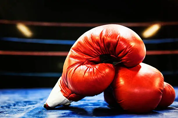 Boxing gloves in boxing ring. Grain added.