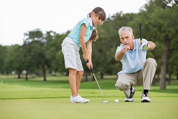 祖父指導少女のゴルフ - golf golf course putting men ストックフォトと画像