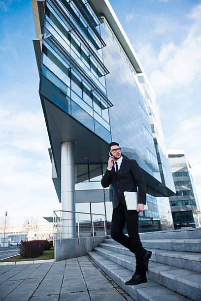 istock Businessman walking in front of office buildings 482803485