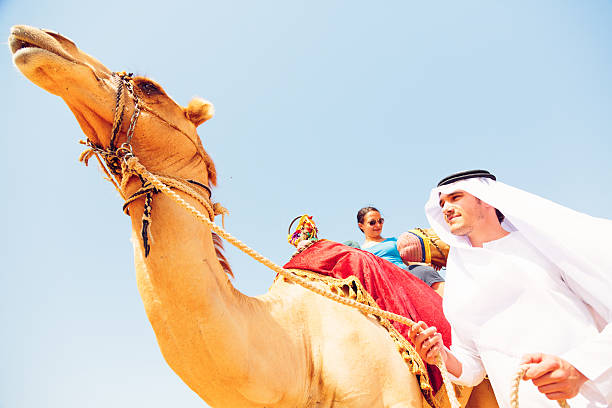 istock arabian man and tourist riding a camel 482803801