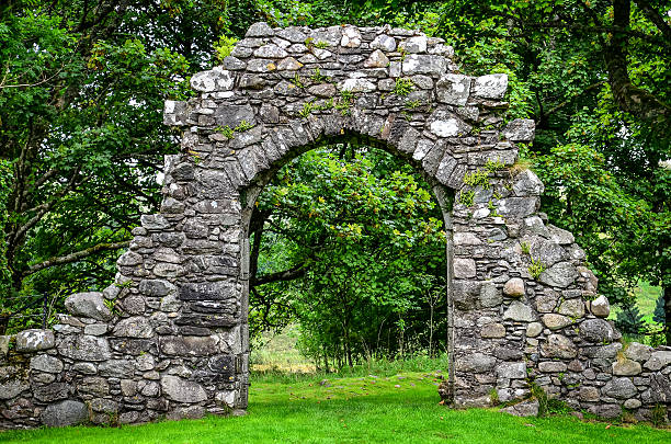Old stone entrance wall in green garden