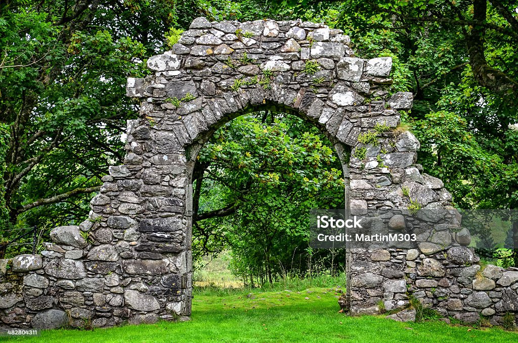 Old stone entrance wall in green garden Old stone entrance wall in green landscaped garden Stone - Object Stock Photo