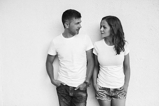 istock Man and woman standing against white wall 482805092