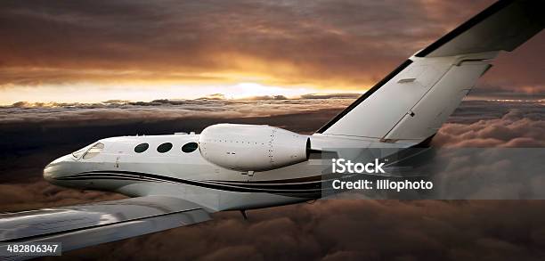 Executive In Flight At Sunset Stock Photo - Download Image Now - Aerodynamic, Air Vehicle, Aircraft Wing