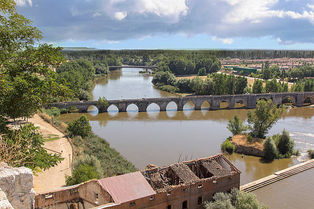 istock Ruins of warehouse next to a river and a bridge 482806417