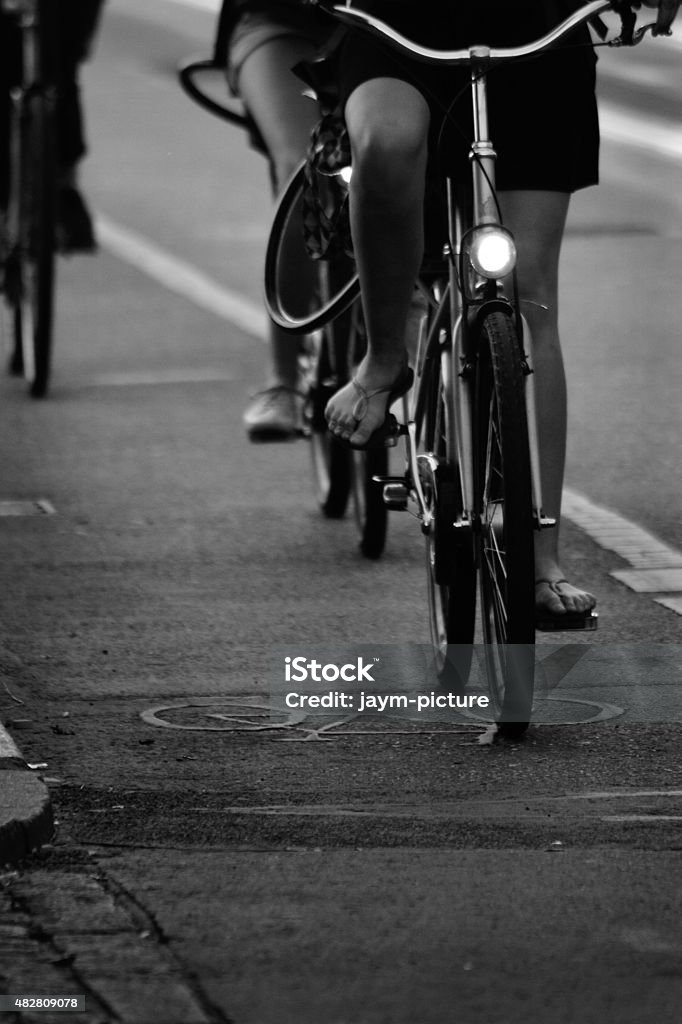bike on citystreet People cycling on citystreet. Cycling Stock Photo