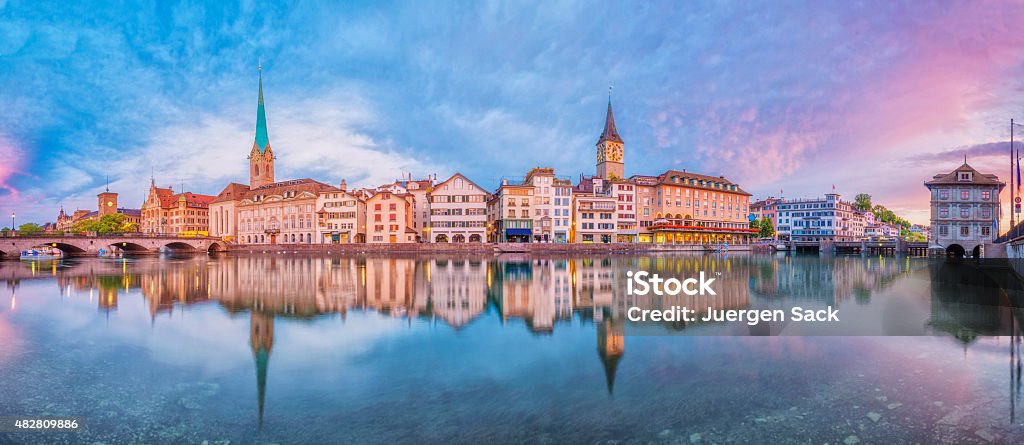 Panoramic view on Zurich at sunrise Panoramic view on Zurich, the river Limmat, Limmatquai, Fraumünster Church (Women's Minster), St. Peter Church and the landmark town hall at sunrise. Zurich Stock Photo