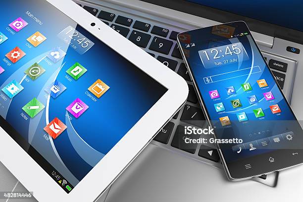 Mobile Devices Tablet Pc Smartphone On Laptop Technology Concept Stock Photo - Download Image Now