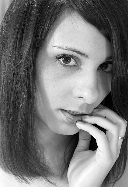 istock Frightened girl gnawing nails (black and white photo) 482817644