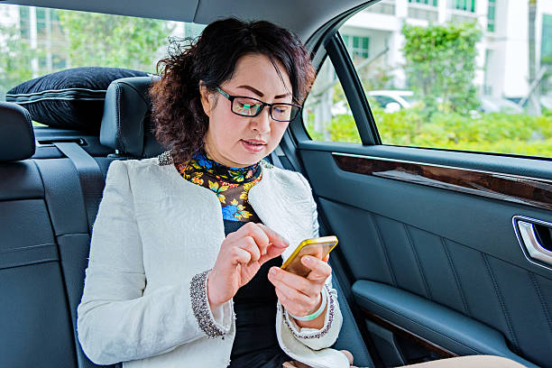 смс - luxury car women smart phone стоковые фото и изображения