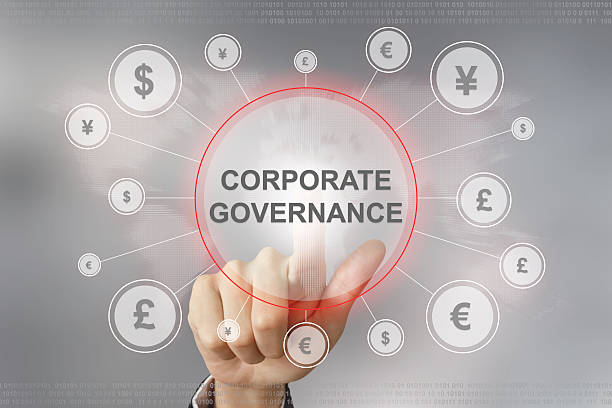 business hand pushing corporate governance button stock photo