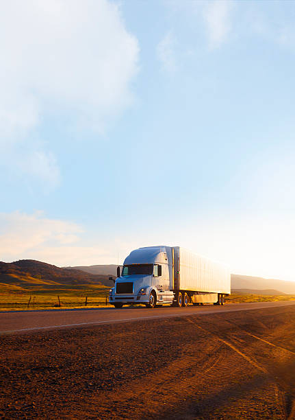 Truck on highway at sunset