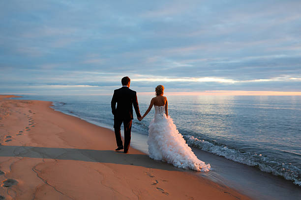 istock Loving couple walking by the sea coast 482818742