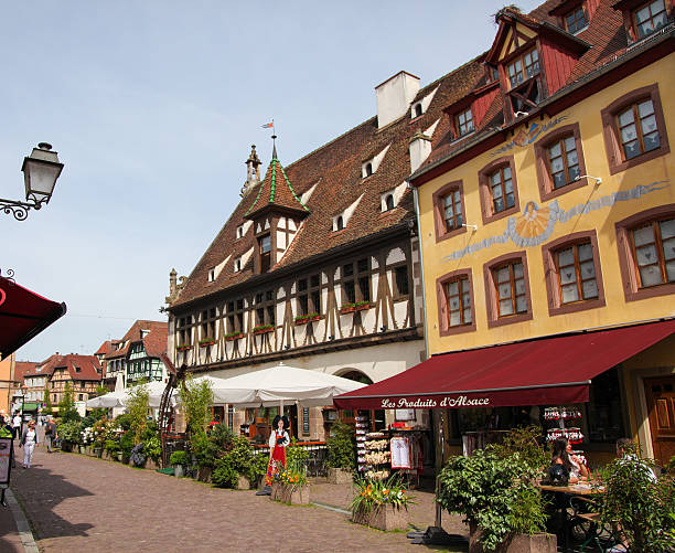 Obernai, France - May 11, 2015: Unidentified people in a street with typical half-timbered houses in Obernai, Alsace, France