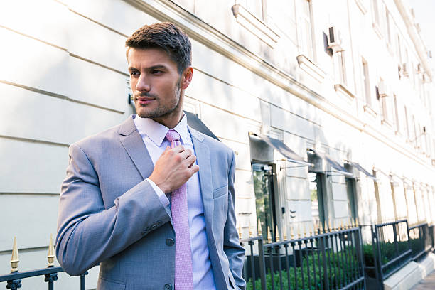 istock Businessman straightens his tie 482823636