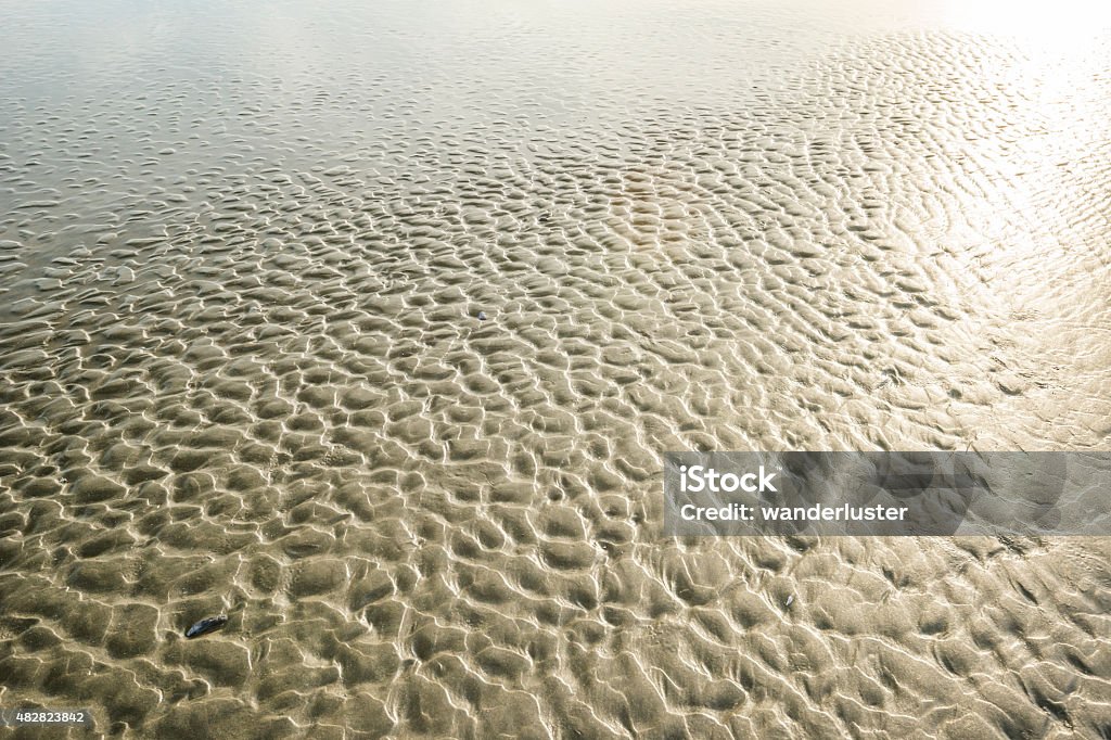 Textured sand on Chesterman beach at low tide Textured rippled sand at low tide on Chesterman beach, Tofino, Vancouver Island, British Columbia, Canada 2015 Stock Photo