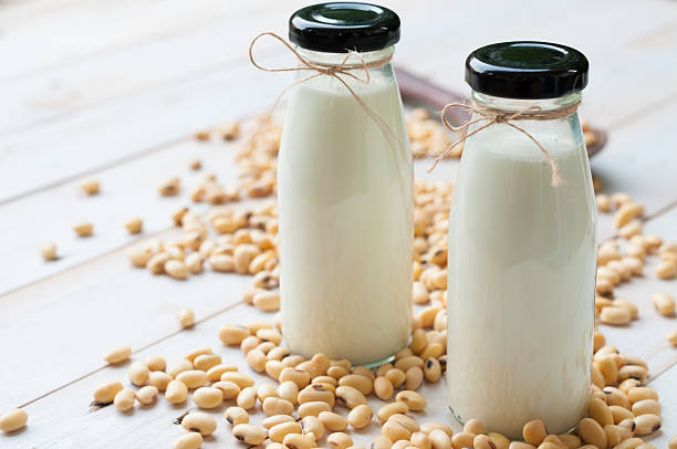 Soy milk in  glass bottle with soy pods stock photo