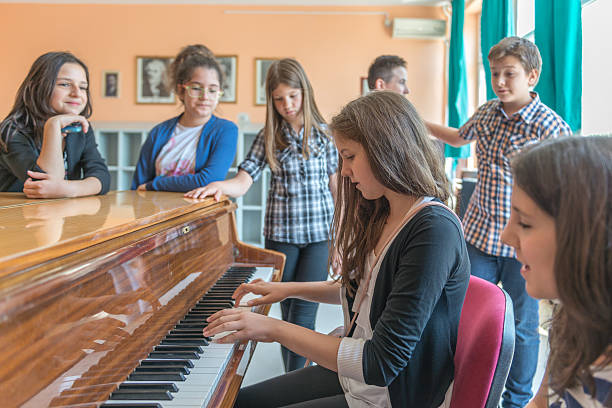 istock Young girl playing the piano 482824130