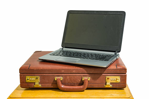 istock laptop and brown briefcase on wood table 482826628