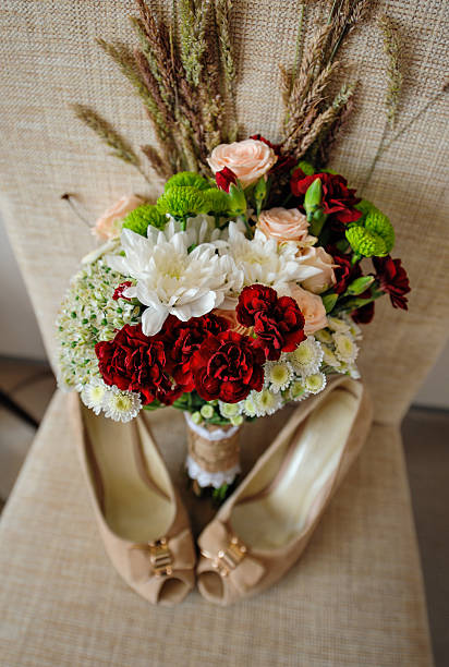 istock beautiful wedding bouquet and bride's shoes on the coffee table 482827094