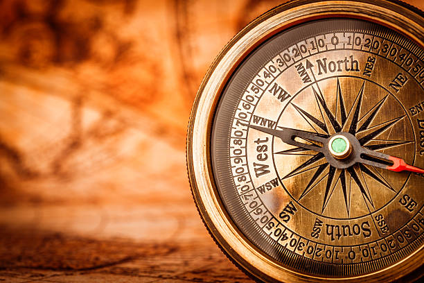 istock Vintage compass lies on an ancient world map. 482828792