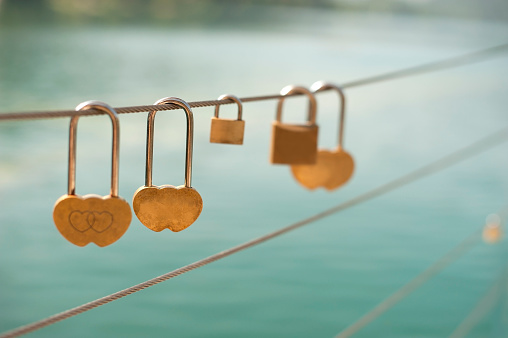 Love locks on the pier against lake.