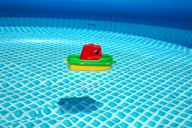 istock Small toy plastic boat floating in a swimming pool 482834124