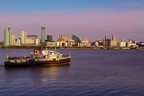 The Ferry across the Mersey and the Liverpool Skyline at dusk.