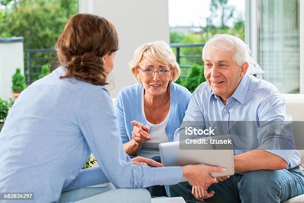 Senior Couple Talking With Insurance Agent Stock Photo - Download Image Now - Advice, Senior Couple, Financial Advisor