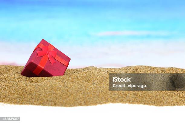 Gift Box With Ribbon On The Sand Stock Photo - Download Image Now - Christmas, Beach, New Zealand