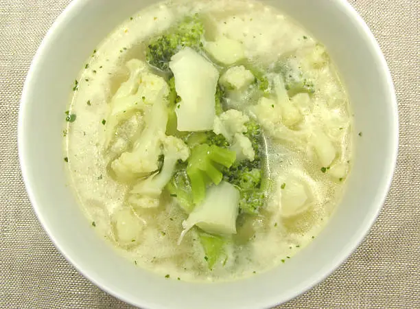 Soup with cauliflower and broccoli in bowl of chinaware