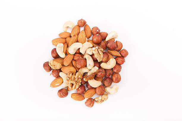 nuts and raisins nuts and raisins dried fruit on white stock pictures, royalty-free photos & images