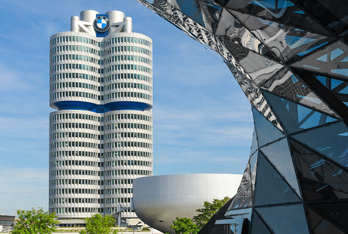 Munich, Germany - September 28, 2014: BMW four-cylinder tower is a Munich landmark which serves as world headquarters for the Bavarian automaker. Stock photo with elements of designs of BMW Museum and BMW Welt (world).