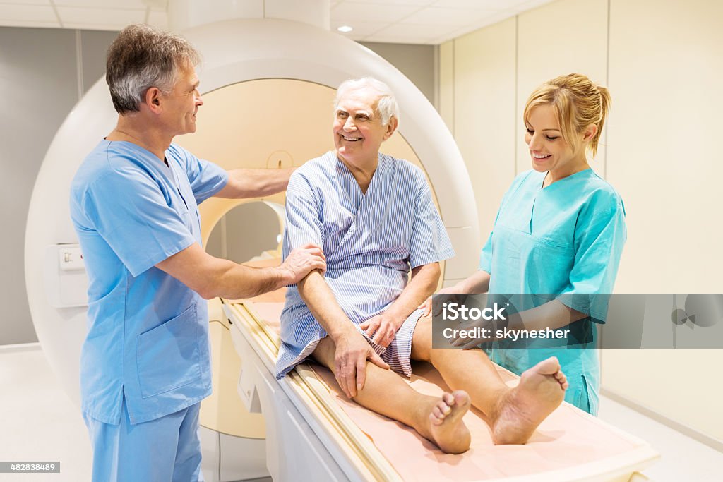 Doctors with a patient. Radiologist talking to a patient after an MRI Scan.   MRI Scan Stock Photo
