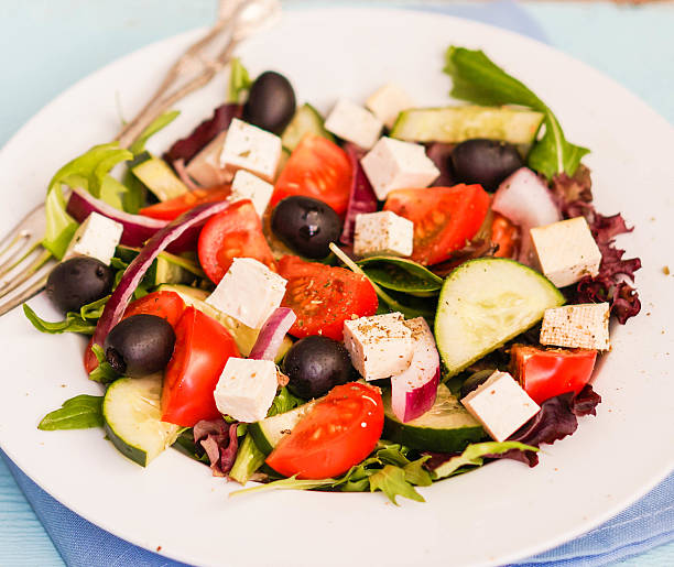istock Greek salad on wooden background 482839271