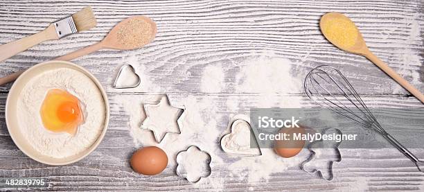 Ingredients And Molds For Baking Cookies On Wooden Background Stock Photo - Download Image Now