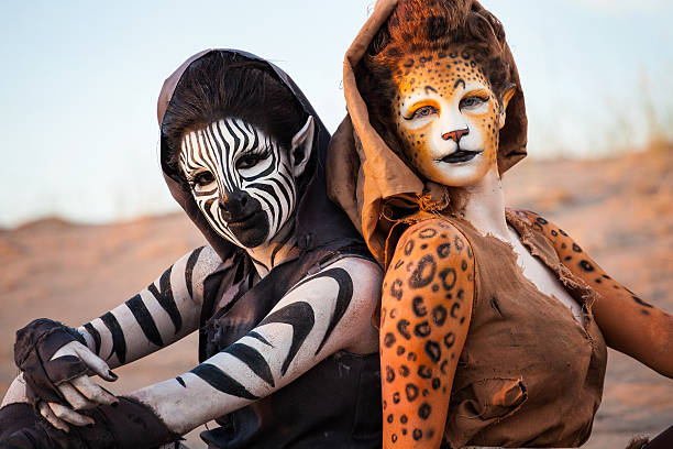 Humanoid Women in the Desert Cheetah & Zebra Woman sitting in the Desert together (Stock Image) cat face paint stock pictures, royalty-free photos & images