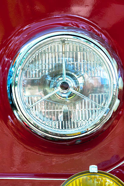 istock Closeup front view of vintage red truck headlight, copy space 482841198