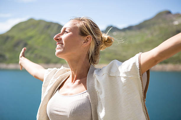 istock Cheering woman enjoying nature-Summer 482841658