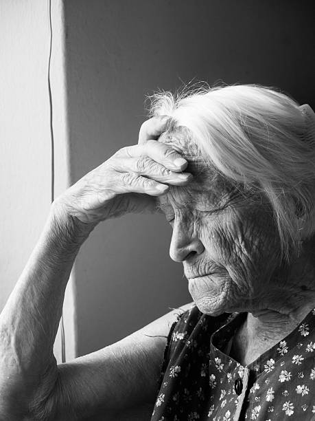 Depressed old lady stock photo