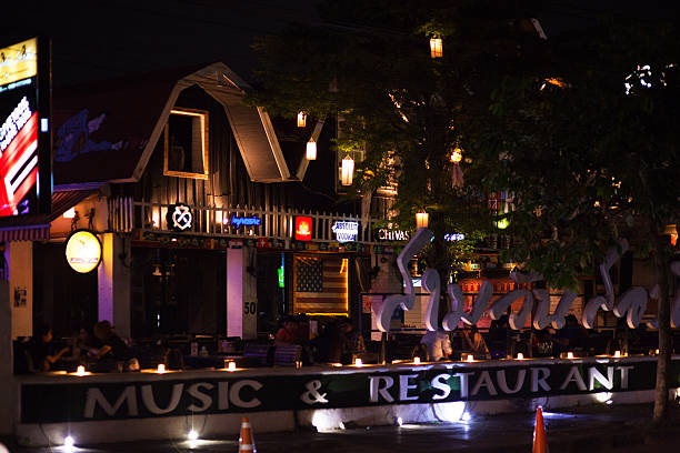 Encinitas, California, USA - September 3, 2022: Evening traffic passes through historic downtown  buildings.