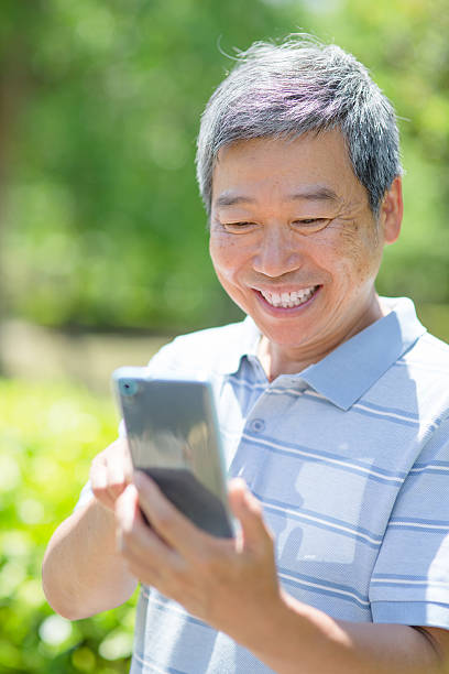 istock old man with smart phone 482850214