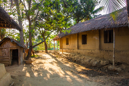 Mud Hut with thatched roof in a village setup of rural Tripura, India.