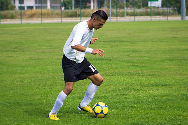 istock Young man playing soccer on soccer field 482851148