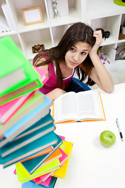istock worried student girl looking in books 482852505