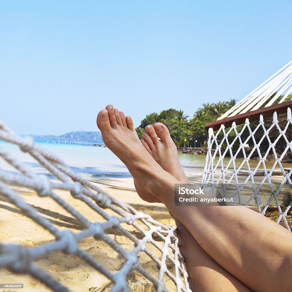 legs in hammock relax on the beach in hammock Hammock Stock Photo