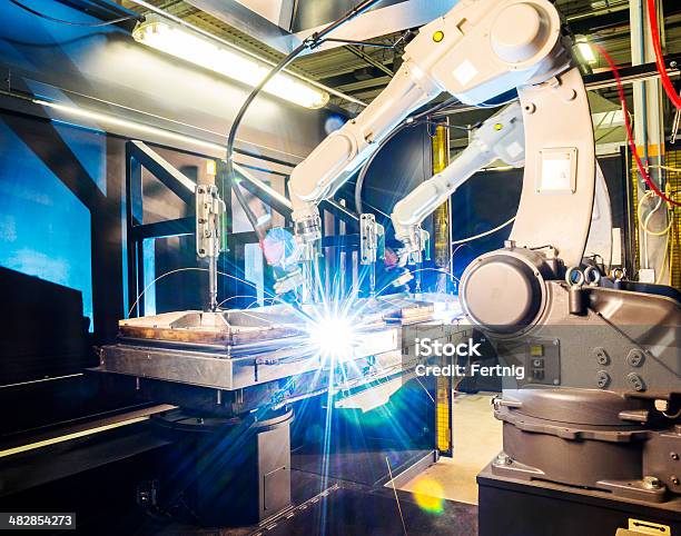 High Tech Robotic Welder In Modern Metal Factory Stock Photo - Download Image Now - Robot, Manufacturing, Welding