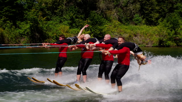Water ski team performers, slow motion